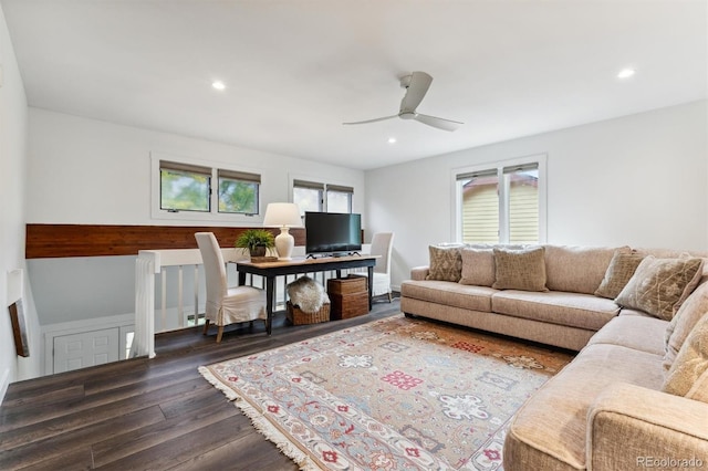 living room with dark wood-type flooring, a wealth of natural light, and ceiling fan