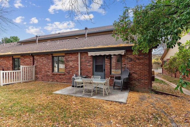 back of house featuring a patio area and a lawn