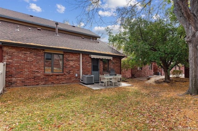 back of property featuring a patio area, a yard, and cooling unit