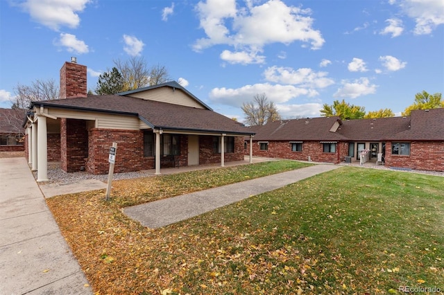 view of front of property with a patio and a front yard