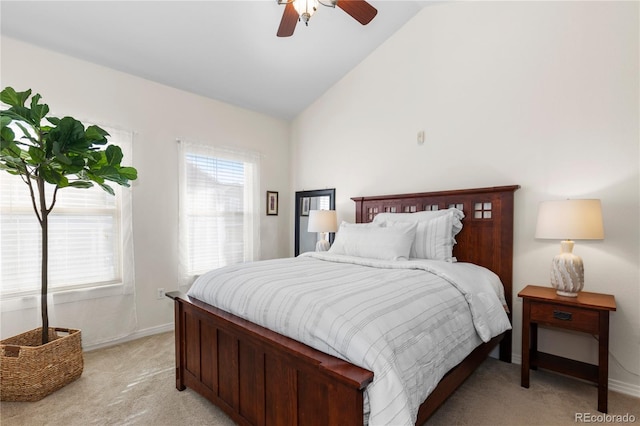 bedroom with a ceiling fan, light carpet, vaulted ceiling, and baseboards