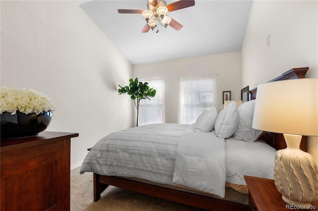 bedroom featuring carpet floors, lofted ceiling, and ceiling fan