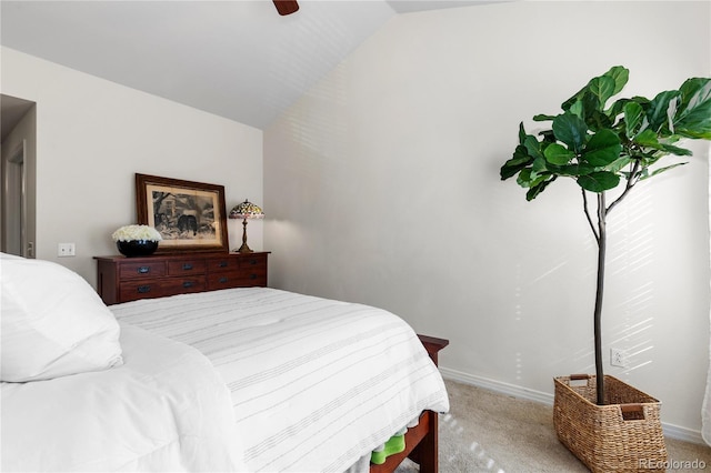 bedroom featuring lofted ceiling, baseboards, a ceiling fan, and light colored carpet