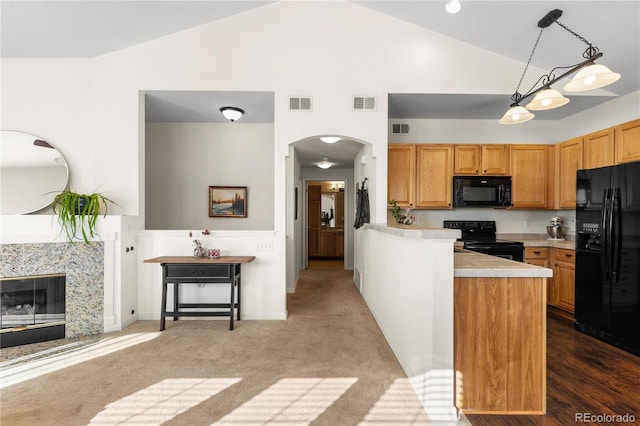 kitchen featuring black appliances, visible vents, light countertops, and arched walkways