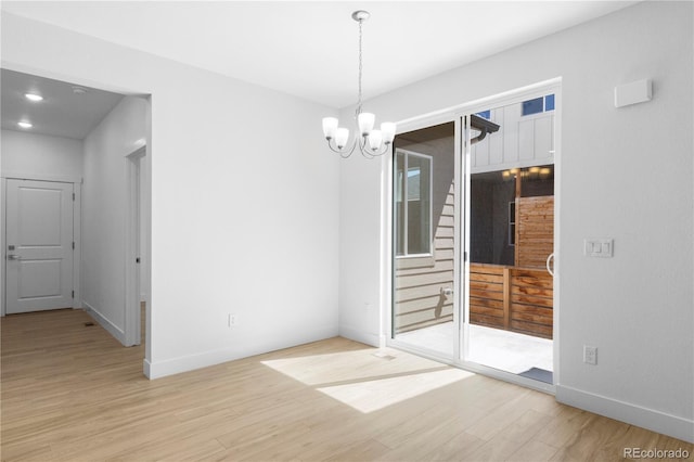 6129 Zebulon Pl, Timnath, CO 80547 - unfurnished dining area with wood finished floors, a chandelier, baseboards, stairs, and recessed lighting