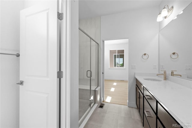 6129 Zebulon Pl, Timnath, CO 80547 - bathroom featuring vanity, tile patterned flooring, a stall shower, and baseboards