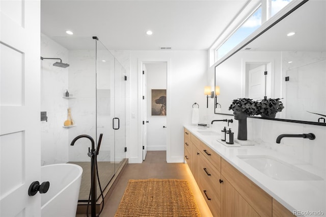 2926 S Cherokee St, Englewood, CO 80110 - full bathroom featuring double vanity, a soaking tub, a stall shower, and recessed lighting