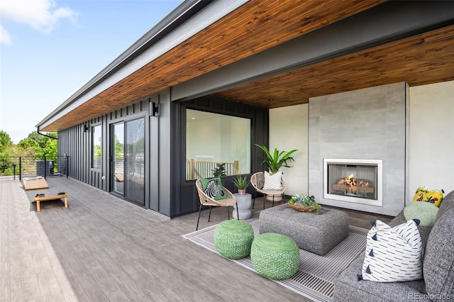 2926 S Cherokee St, Englewood, CO 80110 - wooden deck featuring a lit fireplace