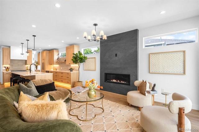2926 S Cherokee St, Englewood, CO 80110 - living room featuring light wood-style flooring, recessed lighting, a chandelier, and a large fireplace