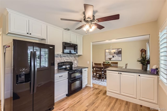 kitchen with black appliances, dark countertops, white cabinets, light wood-style flooring, and tasteful backsplash