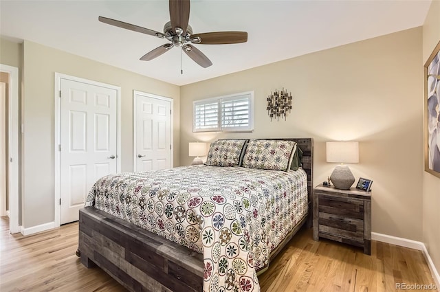 bedroom featuring baseboards, wood finished floors, and a ceiling fan