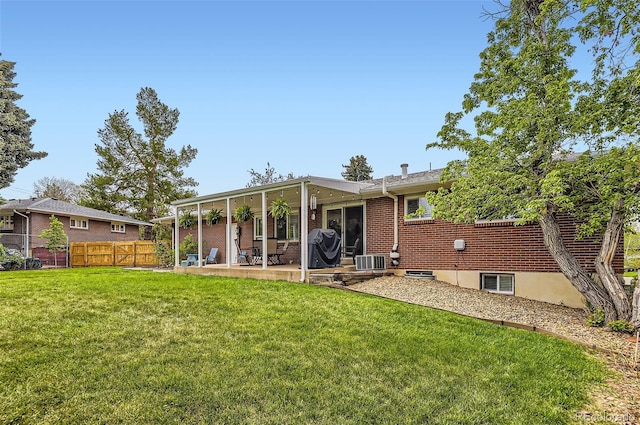 rear view of property featuring a patio area, brick siding, and cooling unit