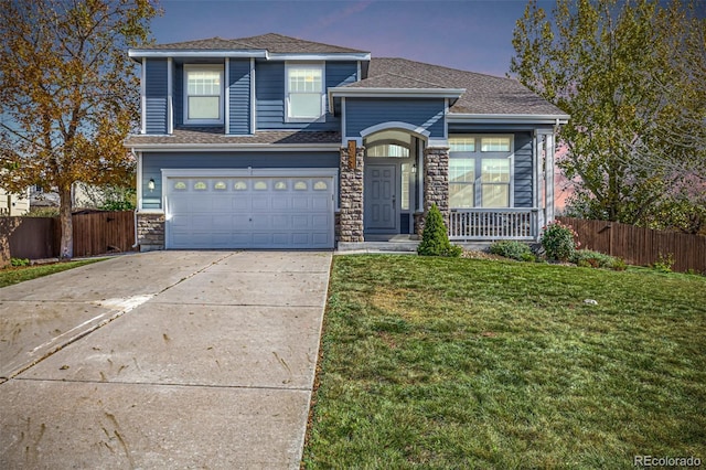 view of property featuring a garage and a lawn