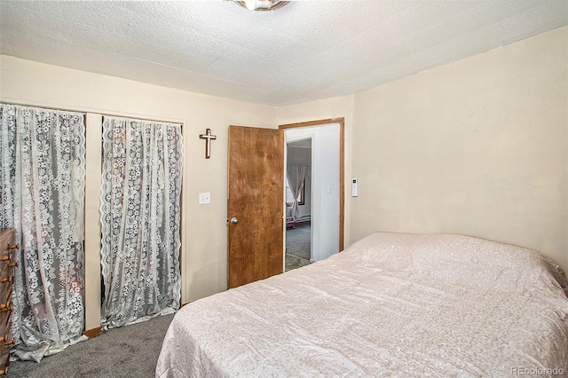 carpeted bedroom with a textured ceiling