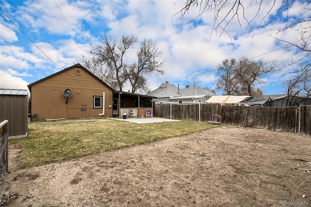 view of yard featuring a storage shed and a patio