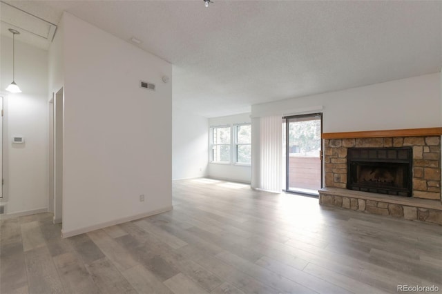 4283 S Salida Way Unit 12, Aurora, CO 80013 - unfurnished living room with light wood-style flooring and a fireplace