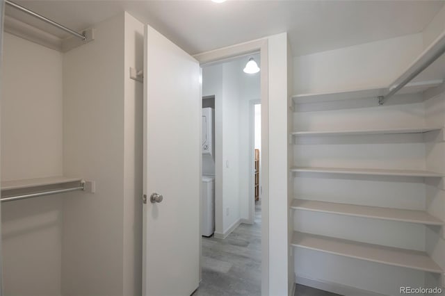4283 S Salida Way Unit 12, Aurora, CO 80013 - spacious closet with stacked washer / dryer and wood finished floors