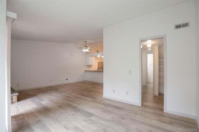 4283 S Salida Way Unit 12, Aurora, CO 80013 - unfurnished living room featuring light wood-type flooring and ceiling fan
