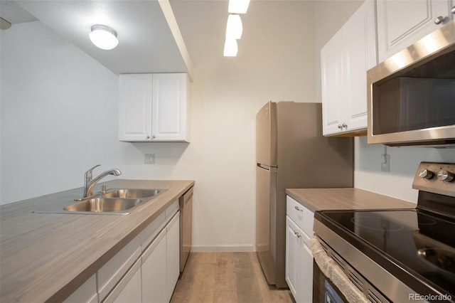 4283 S Salida Way Unit 12, Aurora, CO 80013 - kitchen with appliances with stainless steel finishes, light wood finished floors, white cabinetry, and light countertops