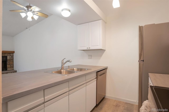 4283 S Salida Way Unit 12, Aurora, CO 80013 - kitchen featuring appliances with stainless steel finishes, a ceiling fan, white cabinetry, lofted ceiling, and light wood-style floors