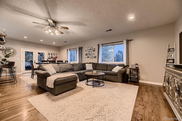 1100 E Harvey St, Castle Rock, CO 80108 - living area with a ceiling fan, dark wood-type flooring, a textured ceiling, recessed lighting, and french doors