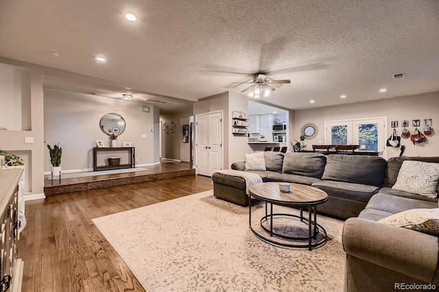 1100 E Harvey St, Castle Rock, CO 80108 - living room with a ceiling fan, dark wood-style flooring, a textured ceiling, and recessed lighting