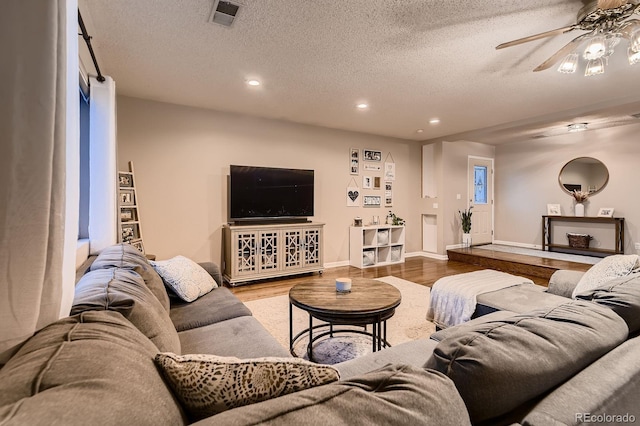 1100 E Harvey St, Castle Rock, CO 80108 - living room with wood finished floors, a textured ceiling, recessed lighting, and a ceiling fan