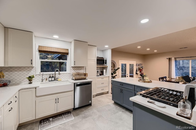 1100 E Harvey St, Castle Rock, CO 80108 - kitchen with stainless steel appliances, light countertops, backsplash, healthy amount of natural light, and recessed lighting