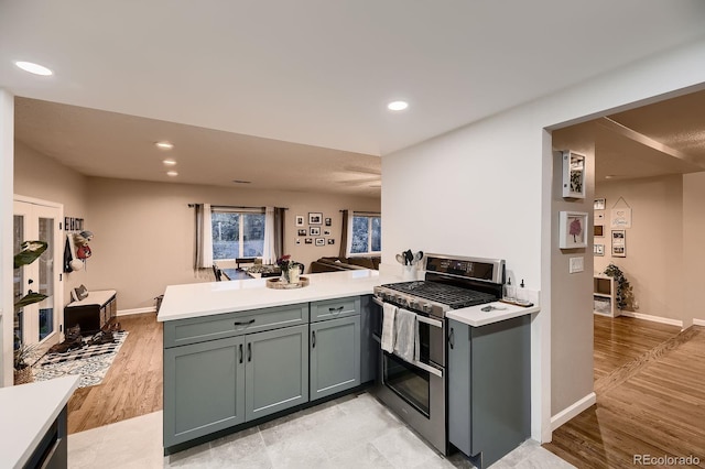 1100 E Harvey St, Castle Rock, CO 80108 - kitchen with double oven range, a peninsula, light countertops, recessed lighting, and light wood-style floors