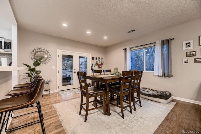 1100 E Harvey St, Castle Rock, CO 80108 - dining space featuring french doors, recessed lighting, light wood-style flooring, and a textured ceiling