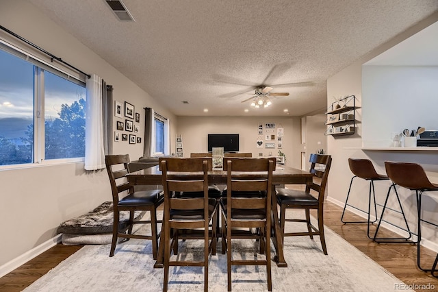 1100 E Harvey St, Castle Rock, CO 80108 - dining area featuring a textured ceiling, a ceiling fan, wood finished floors, and healthy amount of natural light