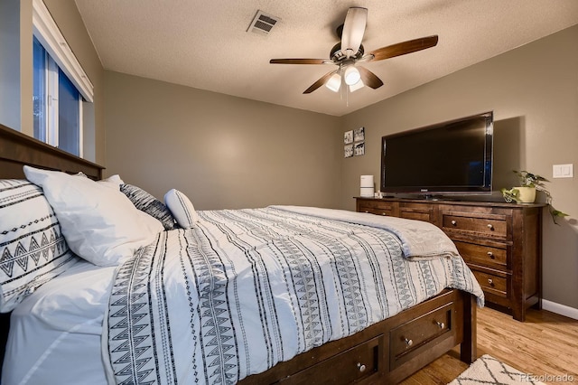 1100 E Harvey St, Castle Rock, CO 80108 - bedroom with light wood-style floors, a ceiling fan, and a textured ceiling