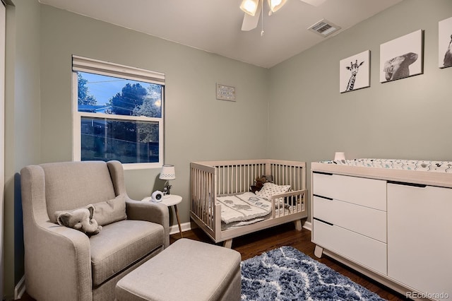 1100 E Harvey St, Castle Rock, CO 80108 - bedroom featuring dark wood-style flooring and a nursery area