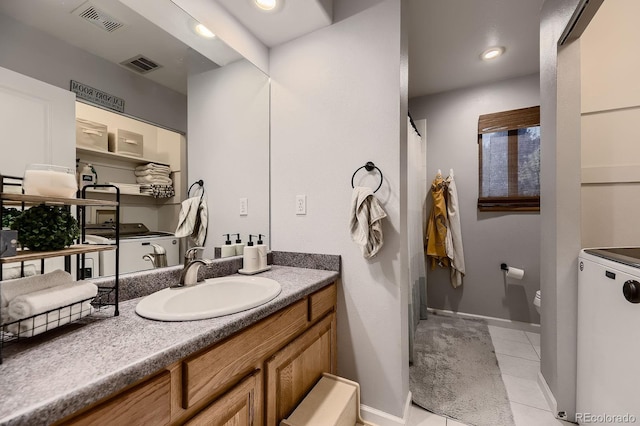 1100 E Harvey St, Castle Rock, CO 80108 - bathroom with tile patterned flooring, vanity, and washer / dryer