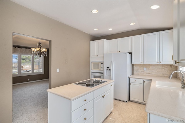 13806 E Chenango Dr, Aurora, CO 80015 - kitchen with white appliances, a sink, white cabinets, recessed lighting, and a kitchen island