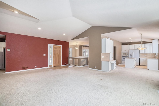 13806 E Chenango Dr, Aurora, CO 80015 - unfurnished living room featuring lofted ceiling, light carpet, and recessed lighting