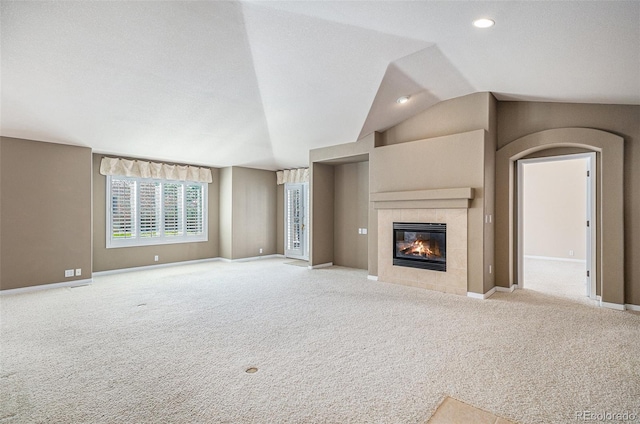 13806 E Chenango Dr, Aurora, CO 80015 - unfurnished living room featuring a tile fireplace, carpet flooring, vaulted ceiling, and recessed lighting