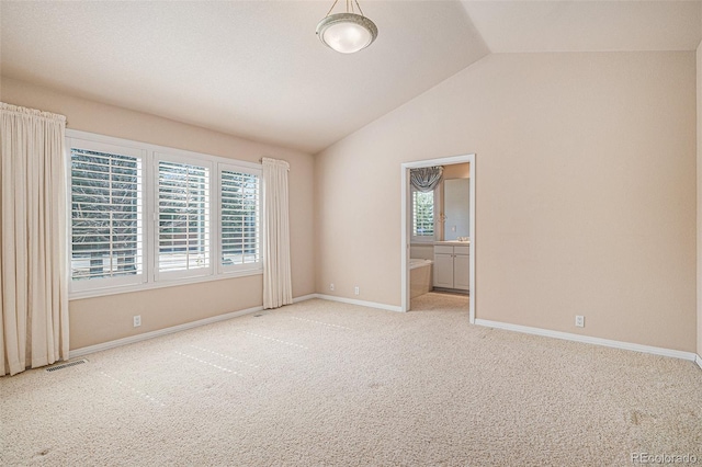 13806 E Chenango Dr, Aurora, CO 80015 - spare room featuring vaulted ceiling and carpet flooring