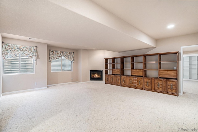 13806 E Chenango Dr, Aurora, CO 80015 - unfurnished living room featuring a glass covered fireplace and baseboards