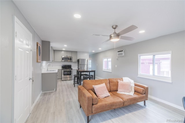 14701 E Colfax Ave Unit A5, Aurora, CO 80011 - living area with light wood-style floors, baseboards, a ceiling fan, an AC wall unit, and recessed lighting