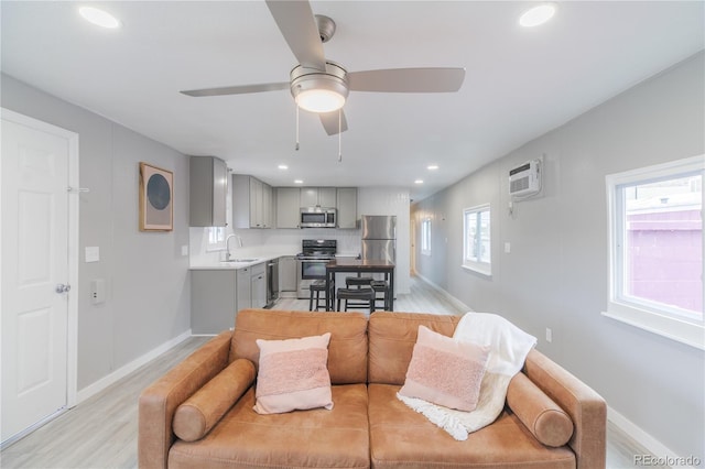 14701 E Colfax Ave Unit A5, Aurora, CO 80011 - living area featuring ceiling fan, light wood-style floors, baseboards, an AC wall unit, and recessed lighting