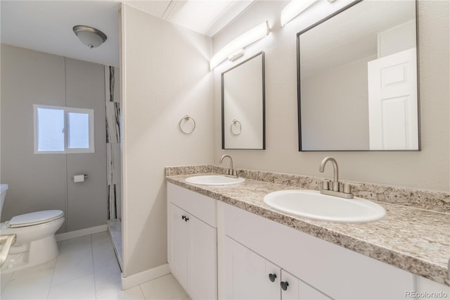14701 E Colfax Ave Unit A5, Aurora, CO 80011 - bathroom with toilet, baseboards, and double vanity
