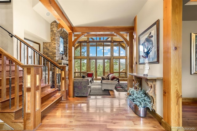 interior space featuring a high ceiling and light hardwood / wood-style floors