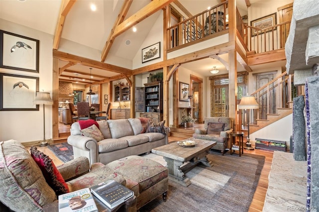 living room featuring high vaulted ceiling, beamed ceiling, and hardwood / wood-style flooring