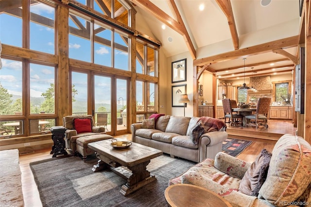 living room with hardwood / wood-style flooring, high vaulted ceiling, beamed ceiling, and plenty of natural light