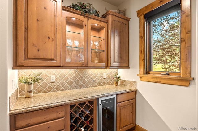 bar with light stone countertops, tasteful backsplash, and wine cooler