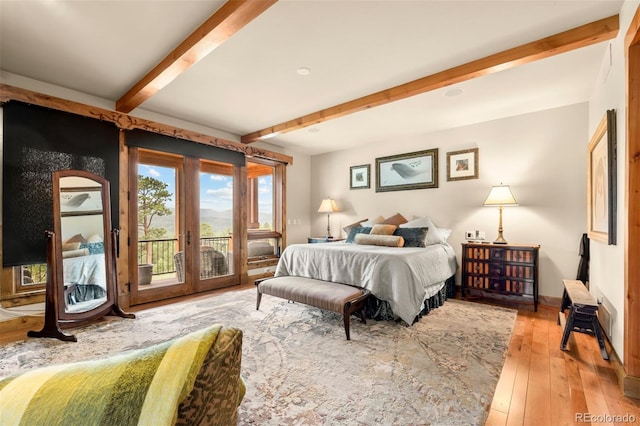 bedroom with french doors, access to exterior, hardwood / wood-style flooring, and beam ceiling