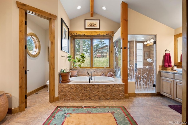 bathroom featuring a relaxing tiled tub, lofted ceiling with beams, vanity, and toilet