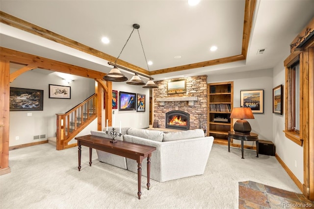 living room featuring a fireplace, built in features, and light carpet