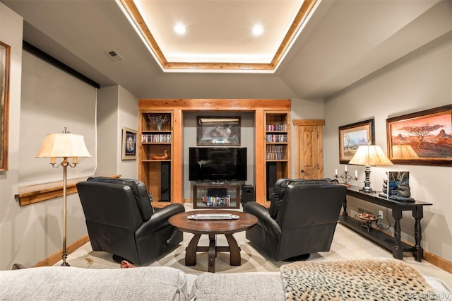 carpeted living room with a raised ceiling